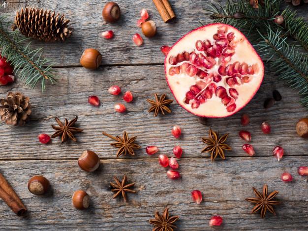 pomegranate-spruce-branches-star-anise-nuts-cinnamon-winter-spices-wood_78677-4869